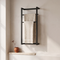 Doppio two bar cast iron towel rack — styled with linen bath towels